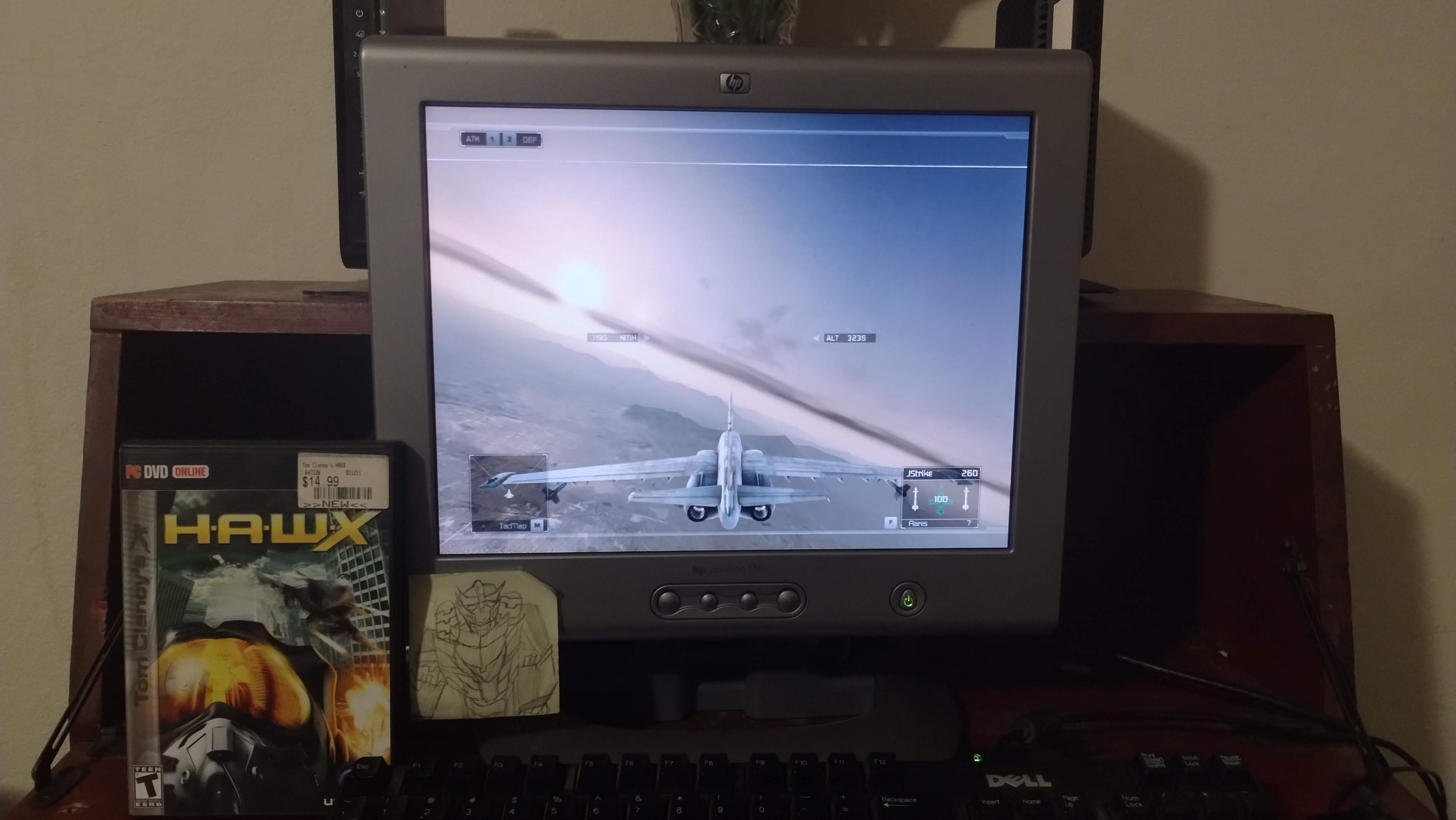 An old monitor displaying a fighter jet flying over a desert. A box for Tom Clancy's HAWX sits in front of it, showing the source of the visual.