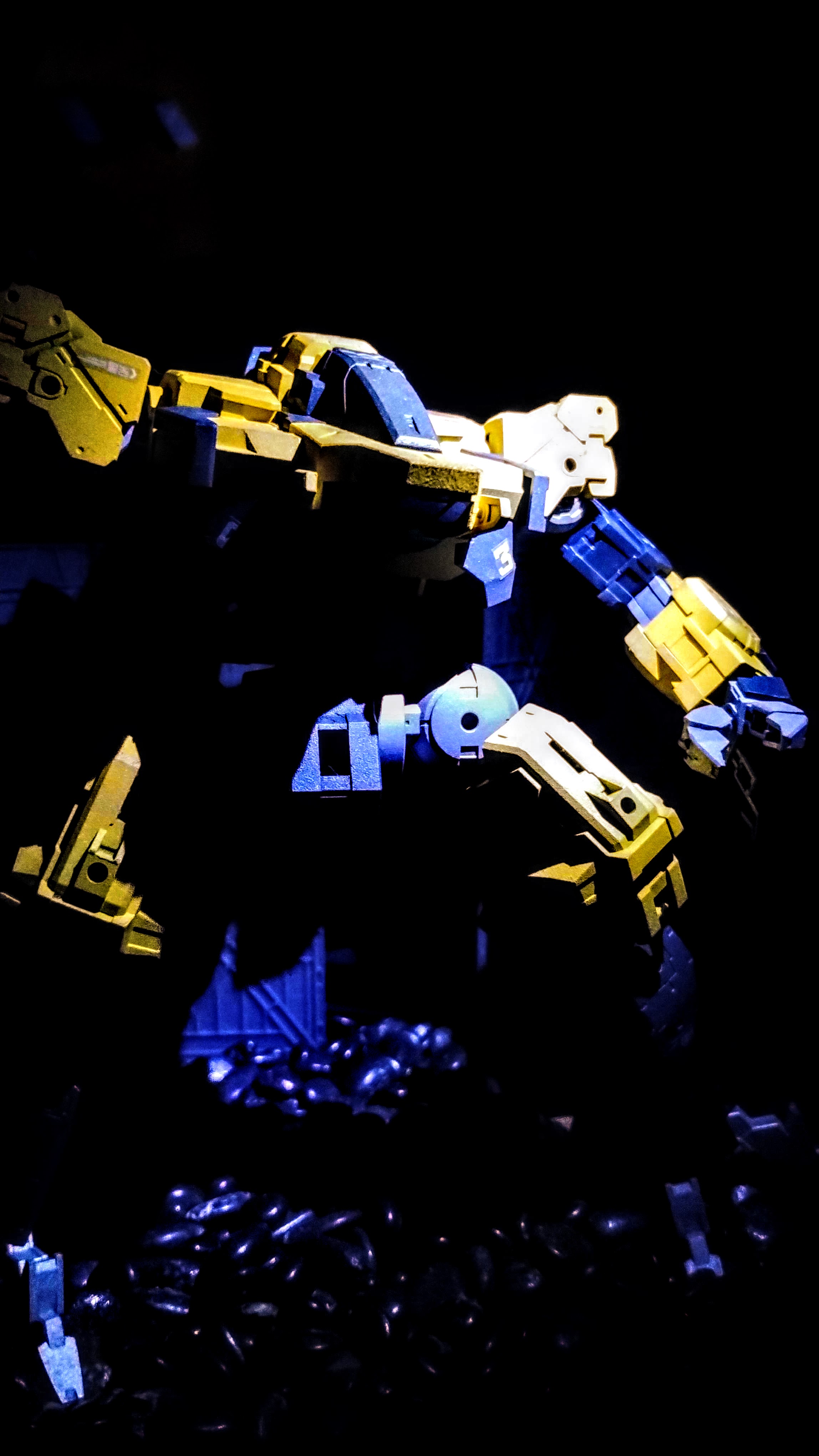 Another picture of the same model in a dark backdrop, with different lighting highlighting different angles of the machine.